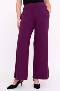 Front view of wide leg plum bamboo pants with pockets and black heels