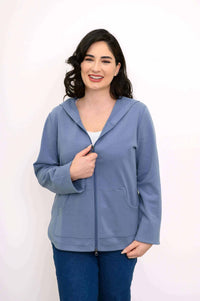 Woman wearing light blue zip-up hoodie jacket facing forward