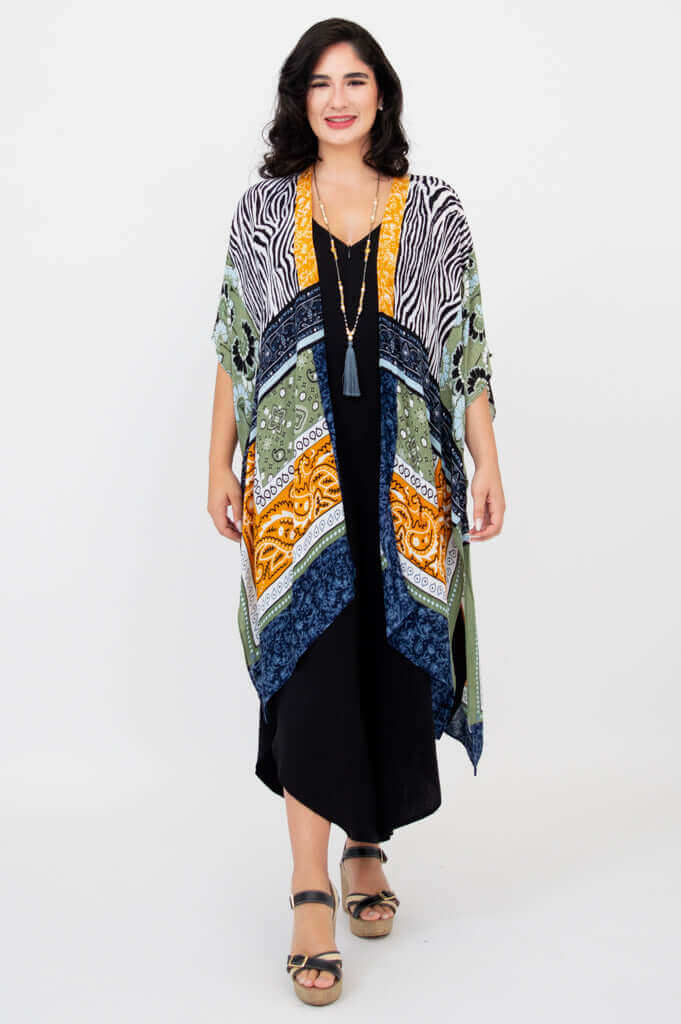 Woman wearing a multi-pattern Darcy kimono wrap over a black jumpsuit, front view