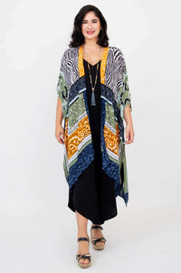 Woman wearing a multi-pattern Darcy kimono wrap over a black jumpsuit, front view