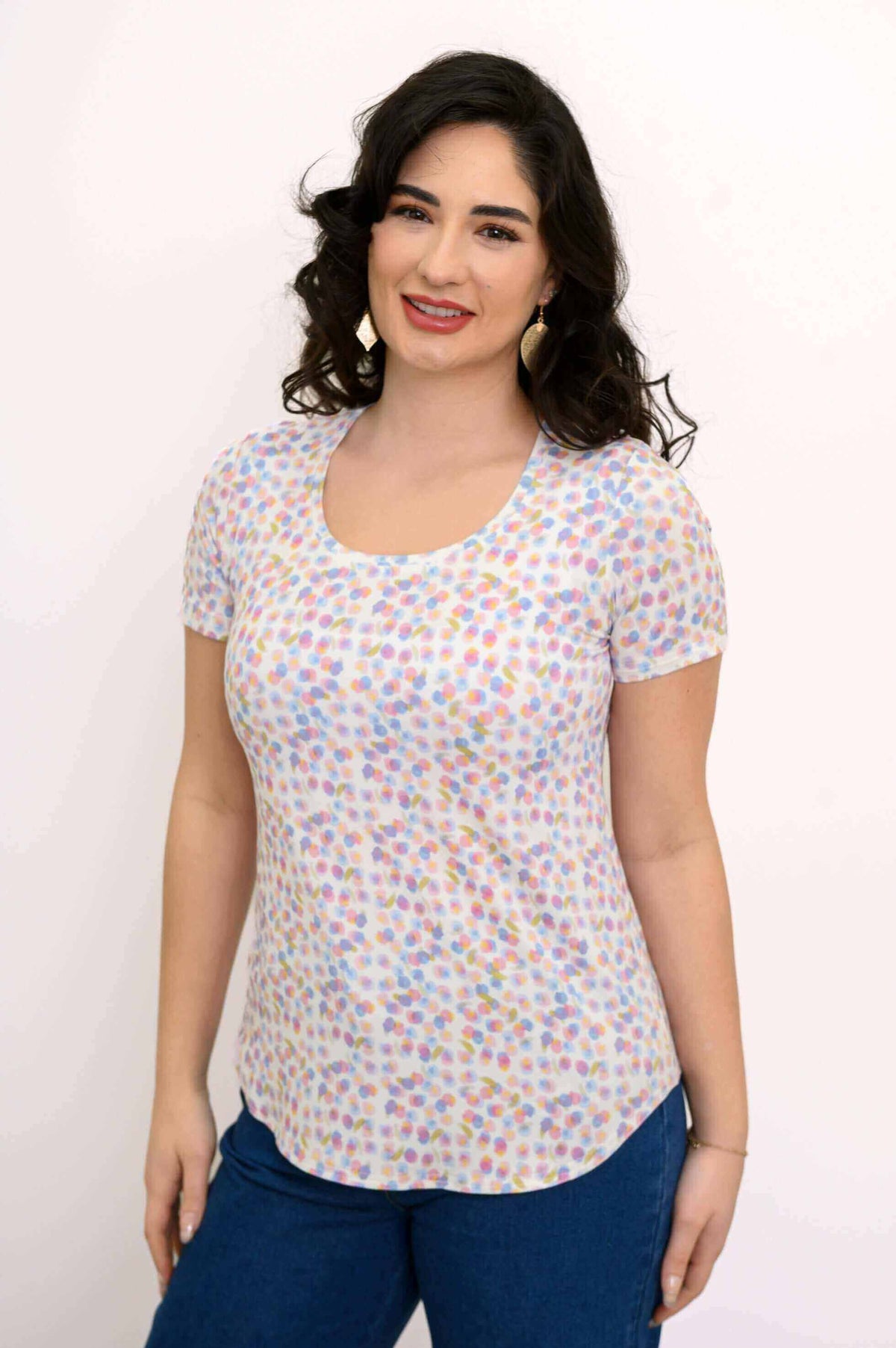 Woman wearing a short sleeve scoop neck Tessa Tee with colorful confetti dot print, front view
