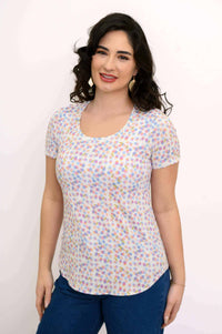 Woman wearing a short sleeve scoop neck Tessa Tee with colorful confetti dot print, front view
