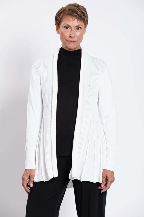 Front view of woman in a white drape-front cardigan with pleated details