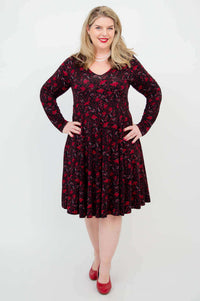 Front view of another woman in black and red floral fit and flare dress