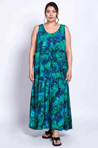 Woman wearing sleeveless blue and green tiered maxi dress, front view
