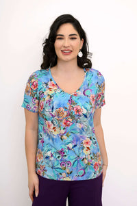 Front view of a woman wearing a short sleeve blue floral bamboo top