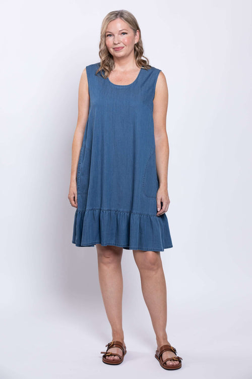 Front view of a woman in a blue sleeveless dress with round neck and ruffle hem