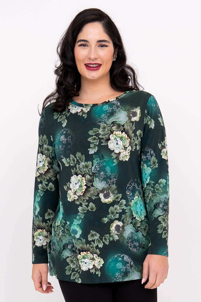 Woman wearing a long sleeve green floral boat neck top, front view