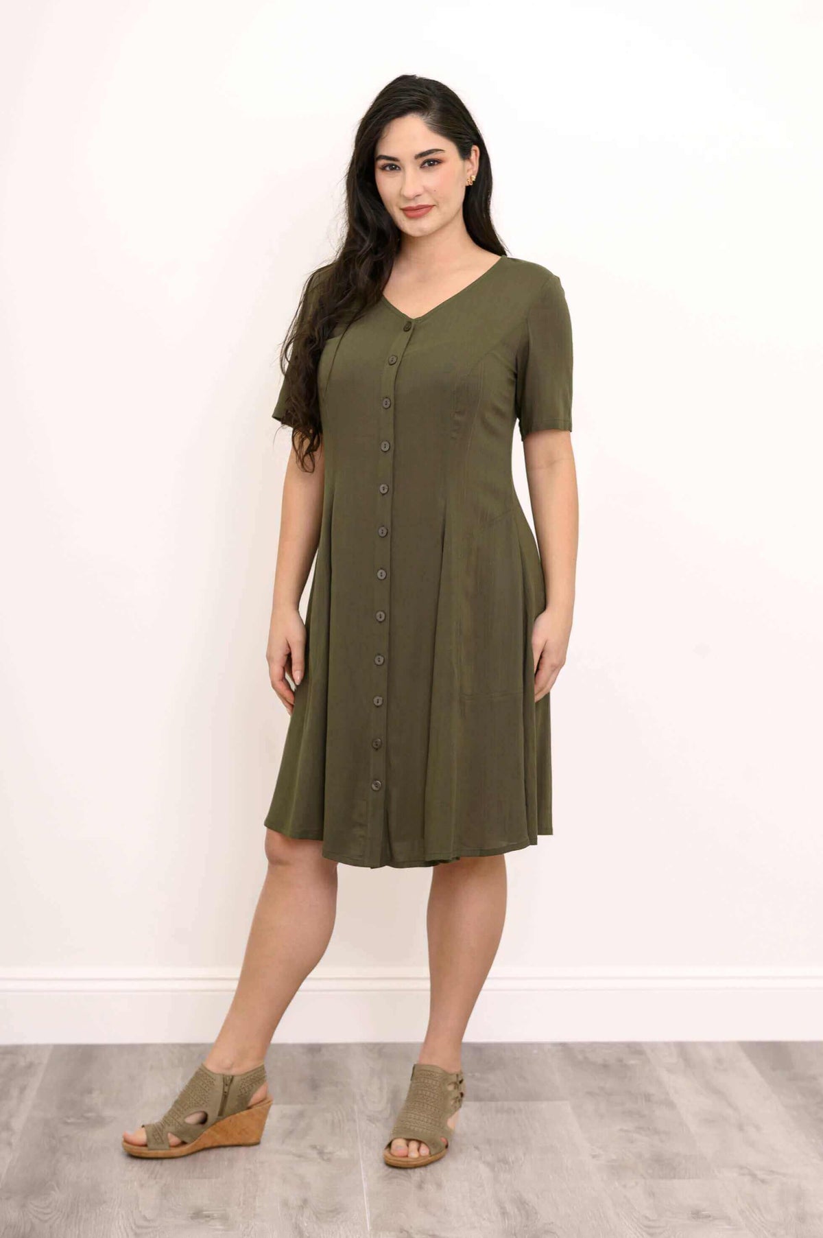 Front view of woman in olive green short-sleeve dress with button-down design