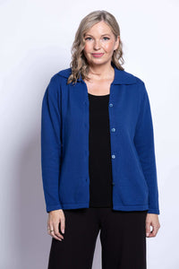 Front view of woman in open royal blue Lily Cardigan layered over black top