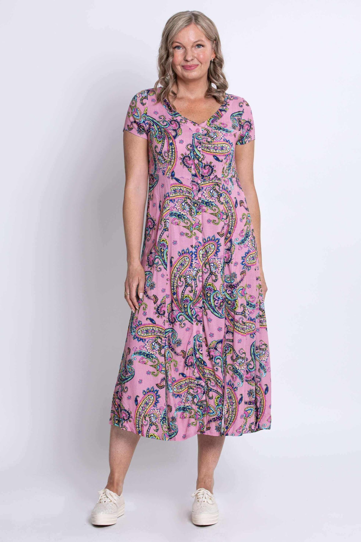 Front view of woman in pink paisley midi dress with short sleeves