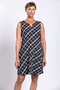 Front view of woman wearing sleeveless black and white plaid shift dress