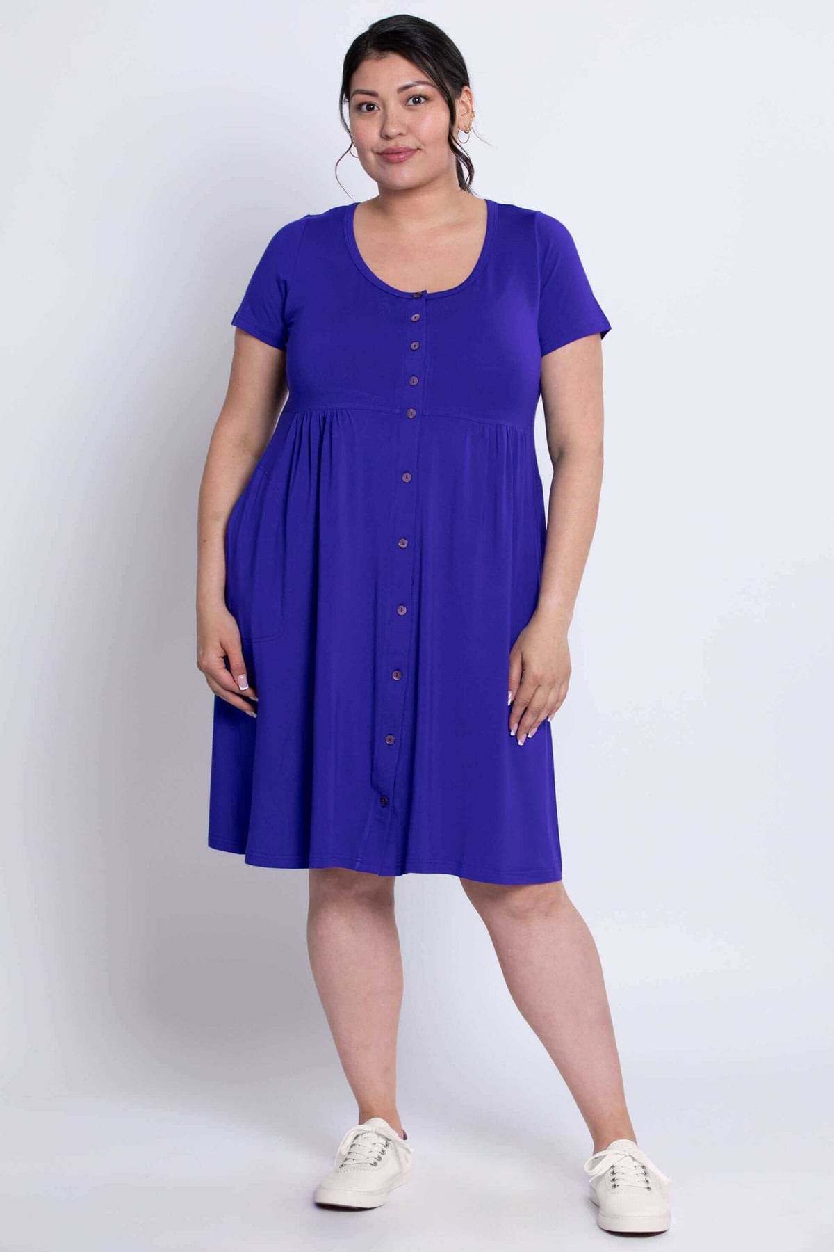 Front view of a woman wearing a short sleeve royal blue button-down dress