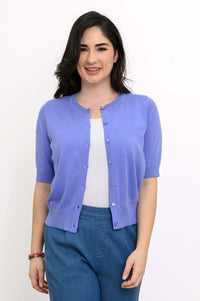 Woman wearing a short-sleeve lavender cardigan over a white top, front view