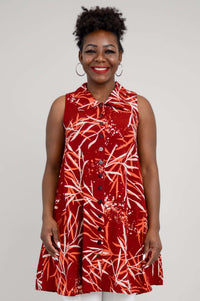 Front view of a woman wearing a sleeveless red A-line tank top with a bamboo print