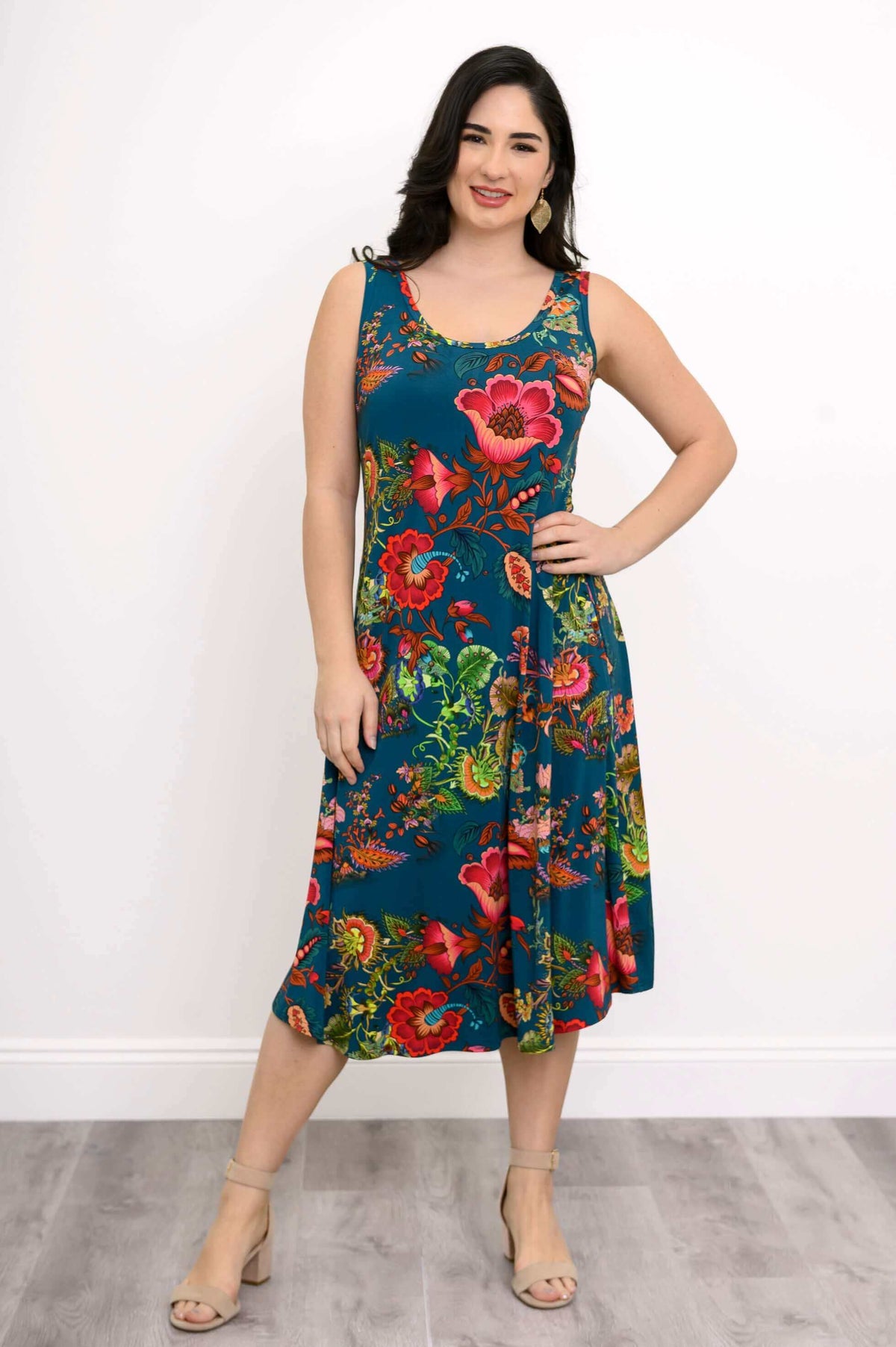 Front view of a woman in a teal floral tank dress with flattering A-line silhouette