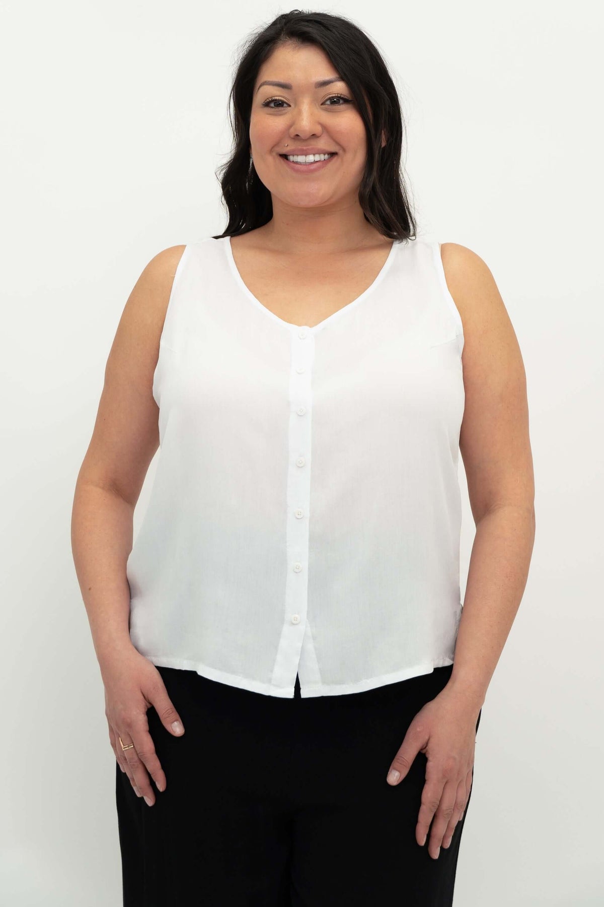 Front view of woman wearing a white button-up sleeveless tank top