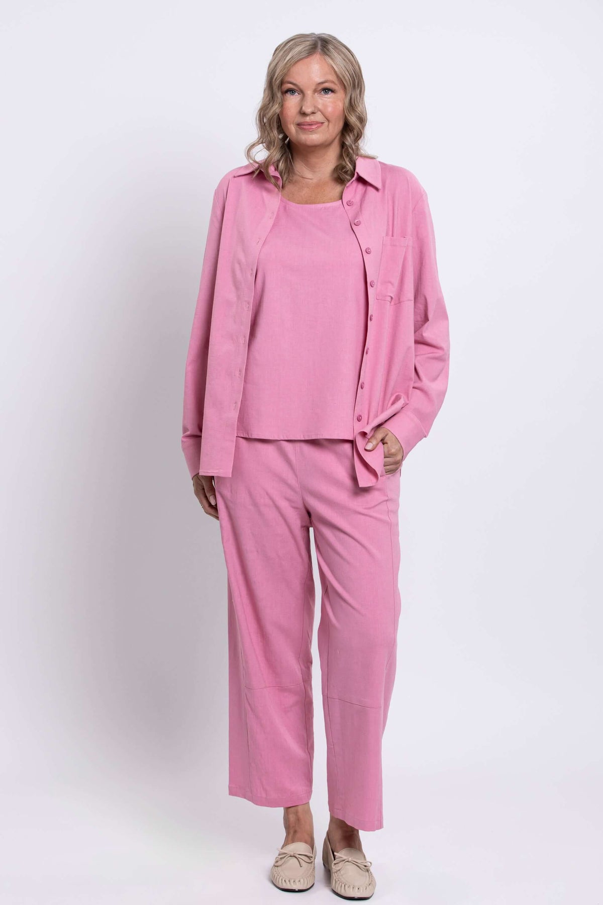 Front view of woman modeling pink linen-blend shirt and wide-leg pants