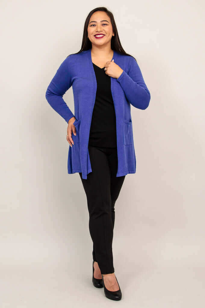 Front view of a woman modeling a royal blue cotton cardigan with pockets