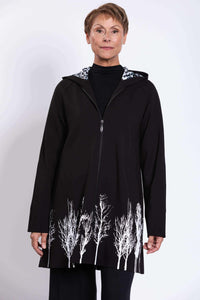 Front view of woman wearing Edith Coat with white silhouetted tree border