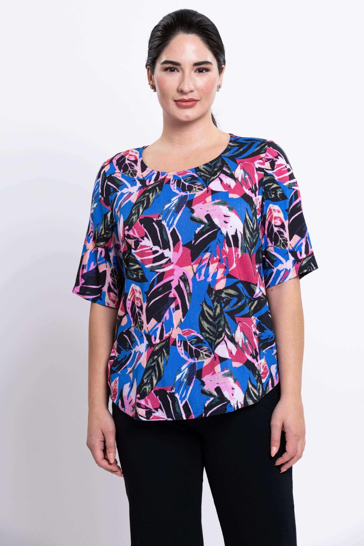 Front view of woman wearing Liza blouse in colorful tropical print