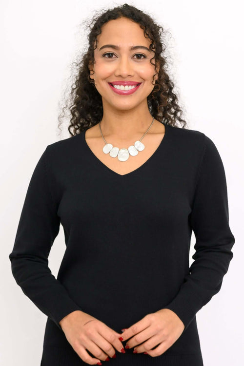 Front view of woman wearing a black V-neck cotton sweater with necklace