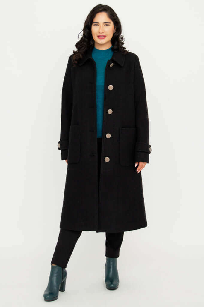Front view of woman wearing a black wool-blend Edna coat with modern silhouette