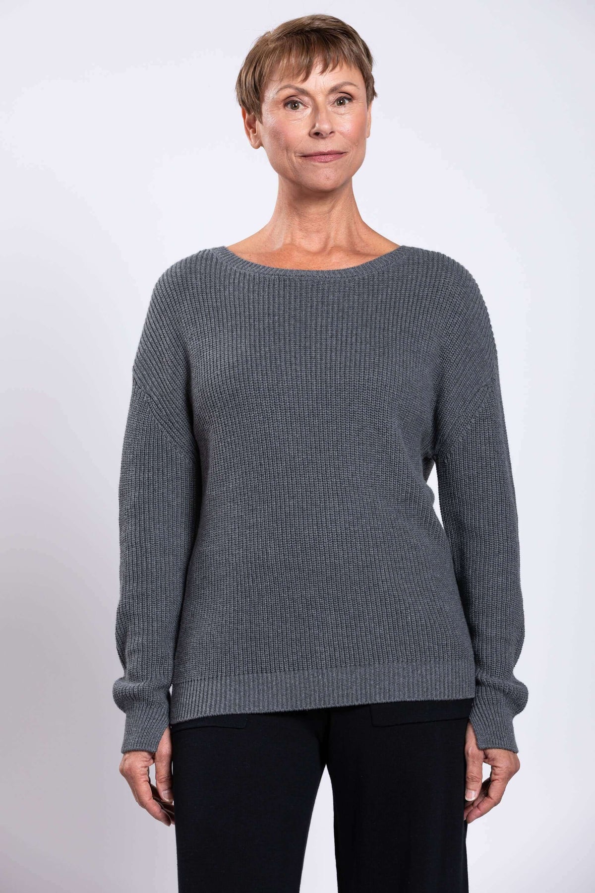 Front view of woman wearing a grey shaker stitch cotton sweater
