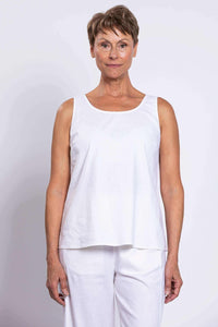 Front view of woman wearing a white linen blend tank top and pants