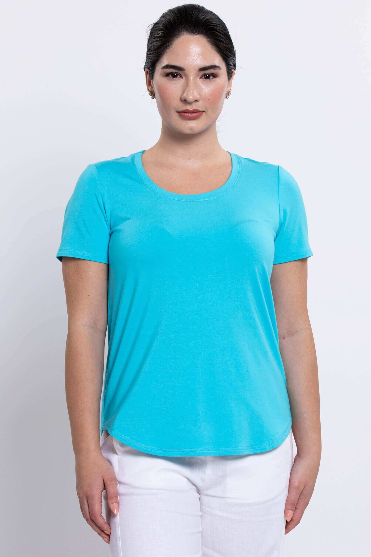 Front view of woman wearing aqua blue Tessa Tee with short sleeves