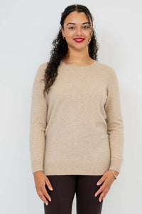 Front view of woman wearing beige crew neck wool cashmere sweater