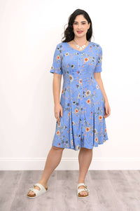 Front view of a woman in a blue floral dress with short sleeves and A-line skirt