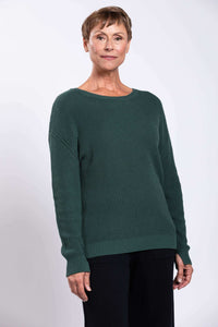 Front view of woman wearing forest green shaker stitch cotton sweater