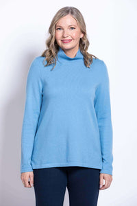 Front view of woman wearing light blue mock neck sweater