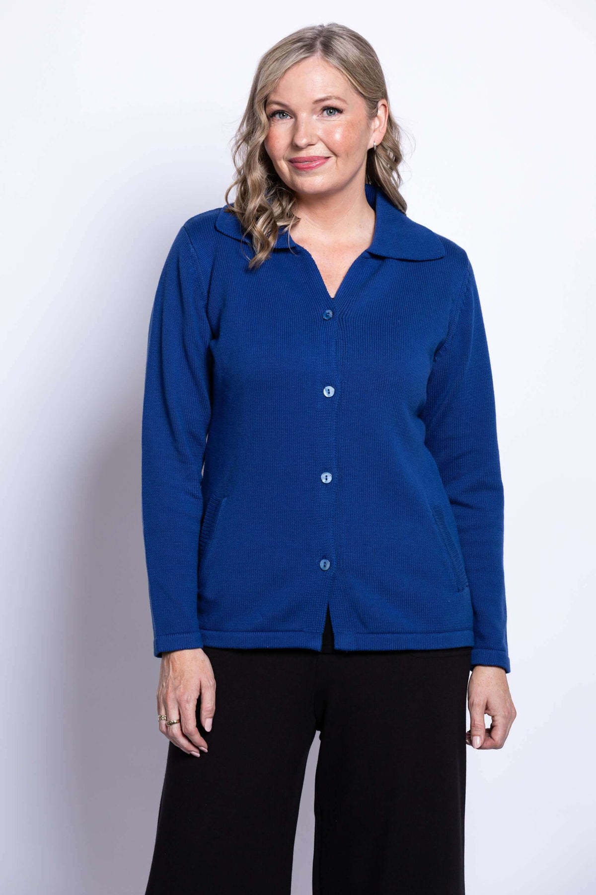 Front view of woman wearing royal blue button-up Lily Cardigan with classic collar