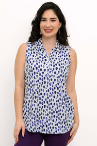 Front view of woman wearing sleeveless blue dot print tank top with collar
