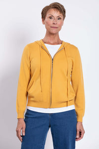 Studio portrait of a model wearing a vibrant yellow long sleeve hooded cardigan with zip closure.
