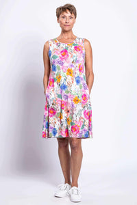 Front view of woman wearing bright floral sleeveless dress with pockets