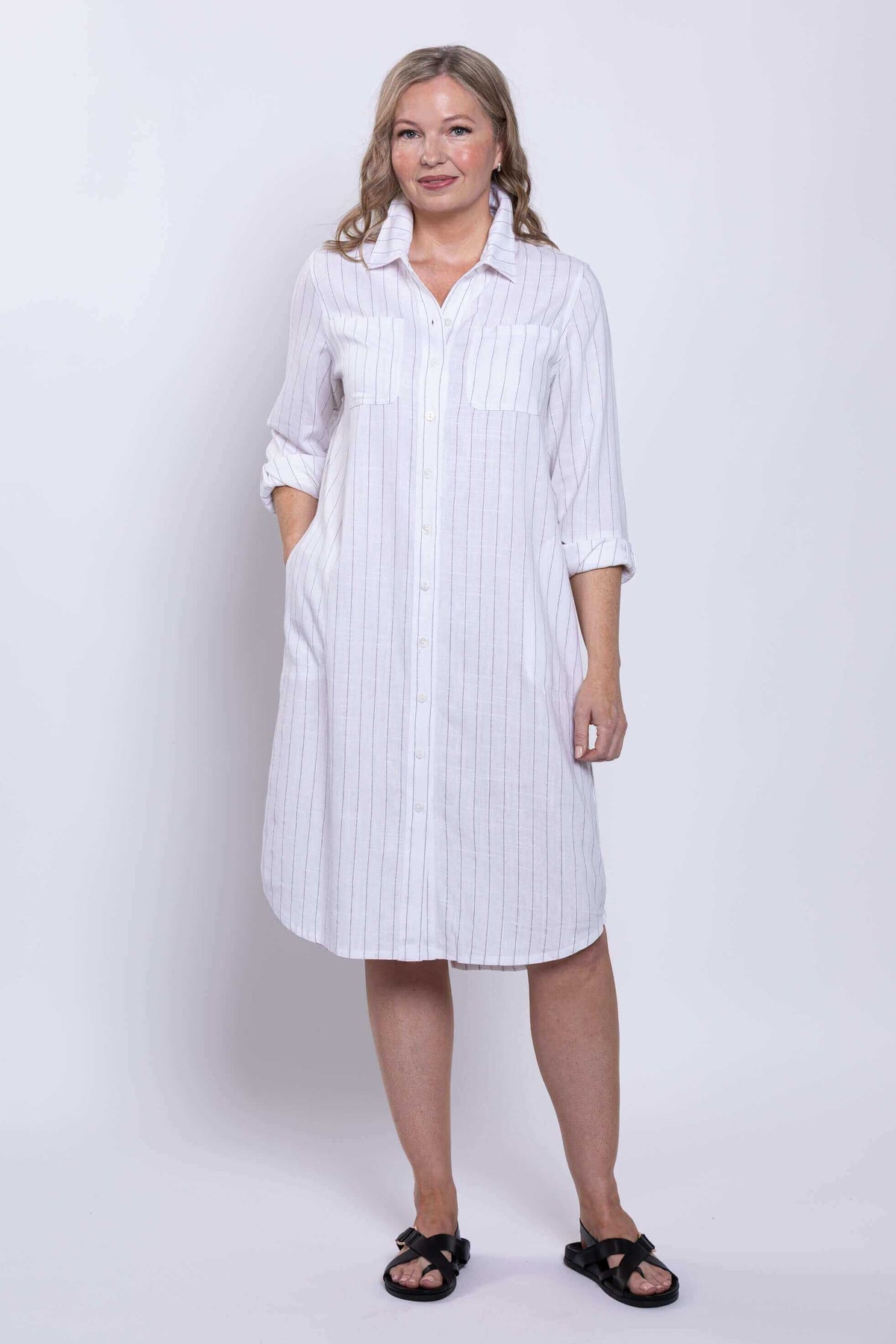 Front view of a model wearing white striped viscose linen duster dress with pockets