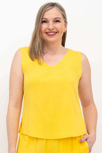 Front view of woman wearing yellow bamboo-linen cropped tank top with V-neck