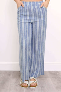 front view of woman with her hands in the pockets of her blue striped pants
