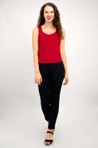 Woman in red tank top and black pants, full-body front view