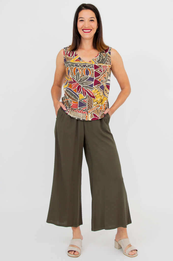 Full-body front view of a woman in a patterned tank top and wide-leg pants