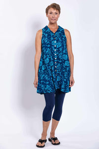 Model showing relaxed fit of blue floral button-up tunic tank with pockets