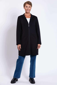 Full-body shot of woman wearing black Tracy Coat paired with jeans