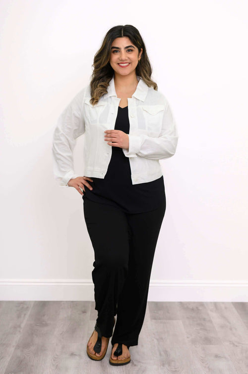 Full-body view of model in a white jean jacket and black pants, standing upright