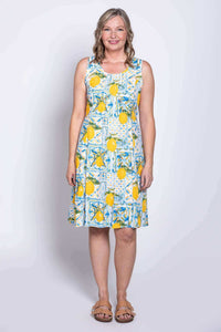 Model posing in a sleeveless yellow lemon print summer dress with a relaxed fit