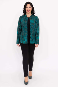 Full-length front view of woman in emerald button-up blouse and black pants