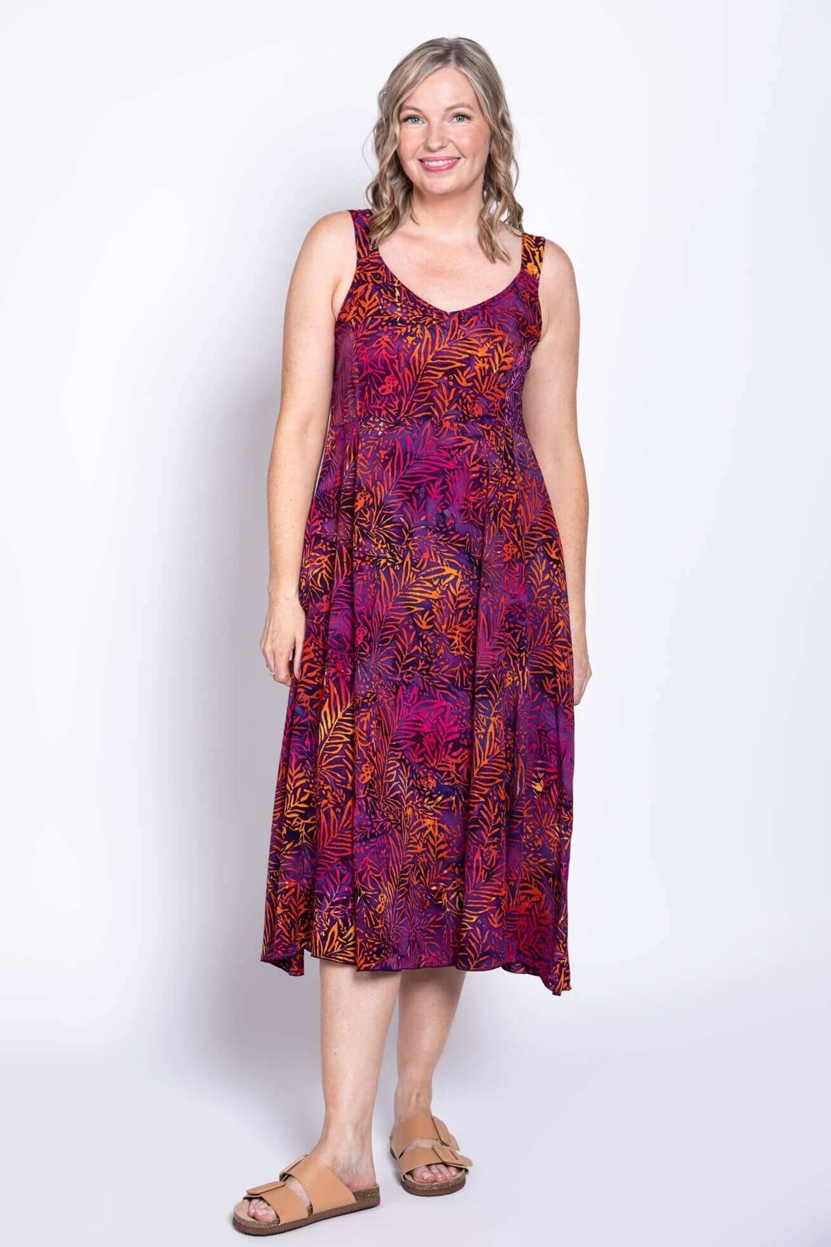 Full-length front view of woman in a purple and orange patterned A-line dress