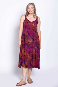 Full-length front view of woman in a purple and orange patterned A-line dress